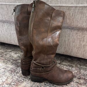 Brown riding boots with gold zipper backing